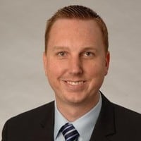 man wearing suit and tie looking at camera